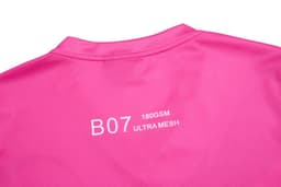 A vibrant pink cheerleader uniform with a smooth texture and branding on the back.