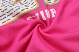 A pink cotton hoodie featuring direct printing with various names and a logo on the front.