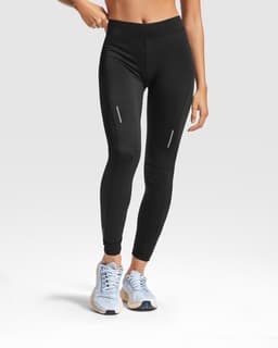 Black leggings with a fitted design, featuring reflective details, paired with light blue sneakers.