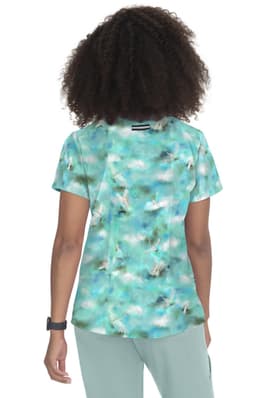 A short-sleeved top featuring a vibrant turquoise and white abstract print, with a logo on the back.