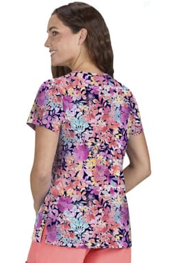 A floral print women's top featuring vibrant colours like pink, purple, and blue, with a relaxed fit and short sleeves.