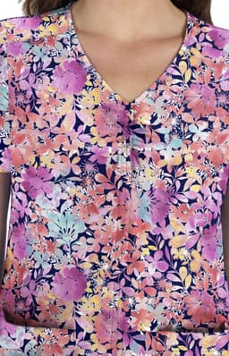 A floral print top featuring vibrant shades of purple, pink, and blue, with a V-neck design and a logo.