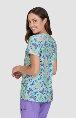 A top featuring a vibrant floral print in shades of blue and pink, with a relaxed fit and a logo on the sleeve.