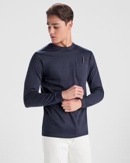 A navy long-sleeved T-shirt featuring a chest pocket, modelled by a young man. The shirt has a simple design and branding.