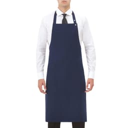A navy blue apron worn by a model, featuring a front pocket and an adjustable neck strap, with a logo present.