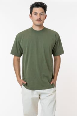 A model wearing a short sleeve, crewneck tee in olive green, featuring a logo on the garment.