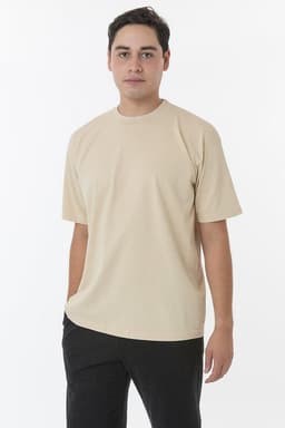 A short sleeve crewneck tee in beige, featuring a relaxed fit and a simple design, shown on a model.