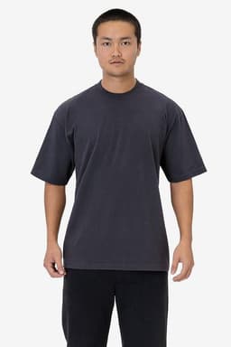 A dark grey short sleeve garment-dyed crewneck tee displayed on a model, featuring a casual fit.