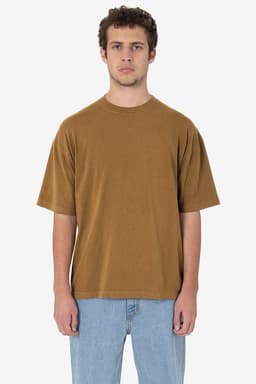 A short sleeve crewneck tee in a rich brown colour, featuring a relaxed fit and a logo. The model has a neutral expression.