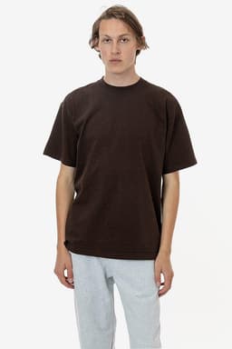 A brown short sleeve crewneck t-shirt with a relaxed fit, paired with grey sweatpants. Features a logo.