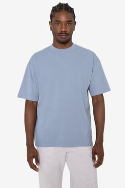 A short sleeve crewneck tee in a soft blue colour, featuring a relaxed fit and a logo on the side.