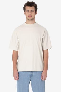 A short sleeve crewneck tee in a light beige colour, featuring a relaxed fit and a logo.