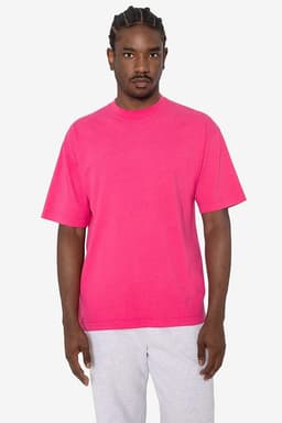 A bright pink short sleeve crewneck tee with a relaxed fit, featuring a logo on the front.