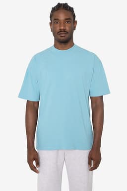 A light blue short sleeve crewneck tee displayed on a model, featuring a relaxed fit and a logo.