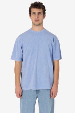 A blue short sleeve crew tee, featuring a relaxed fit and mineral wash texture, displayed on a model.