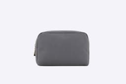 A grey zipper bag with a simple, minimalist design and a logo on the side.
