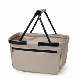 A beige shopper basket with a black frame and handle, featuring a zippered pocket on one side.