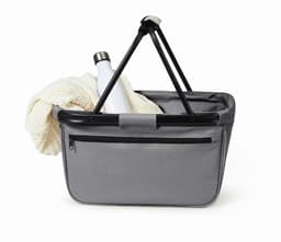 A grey tote bag with a black handle, featuring a drink bottle and a knitted item inside. It has a front zip pocket and a branding logo.