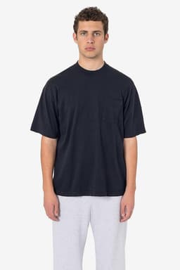 A black short sleeve pocket tee with a relaxed fit and a casual style, worn with grey pants. The shirt features a logo.