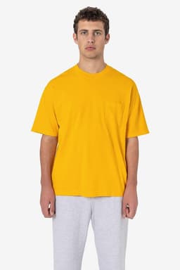 A yellow short sleeve pocket tee worn with grey pants, featuring a basic design and a logo.