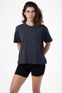 A model stands wearing a charcoal garment dye wide tee and black shorts, showcasing a relaxed fit and casual style.