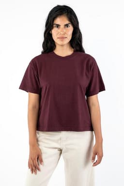 A maroon garment dye wide tee with short sleeves, displayed on a model against a plain background.