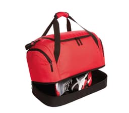 A red duffle bag with black accents featuring a zippered compartment for shoes. It has sturdy handles for easy carrying.