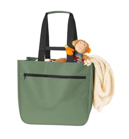 A green tote bag with black straps, featuring a stuffed monkey and a blanket inside.