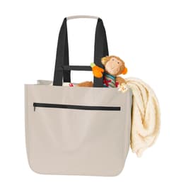 A soft beige bag with black straps, featuring a cuddly toy monkey and a blanket peeking out. It has a zipper pocket.