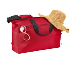 A red duffle bag with black straps, featuring a pair of sunglasses and a straw hat resting on top.