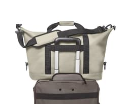 A beige duffle bag with black straps, featuring a retractable handle and a zipped compartment. Includes a branding logo.