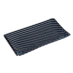 A neck scarf in navy blue with cream diagonal stripes, featuring a branded logo.