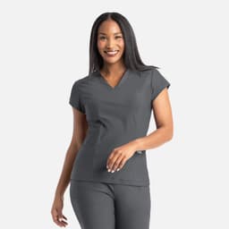A grey banded V-neck top with short sleeves, worn by a smiling woman. The top features a logo on it.
