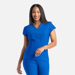 A blue banded v-neck top with short sleeves, featuring a logo on the chest, worn by a smiling woman.