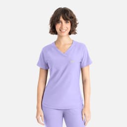 A lavender Y-neck top with short sleeves, featuring a logo on the front.