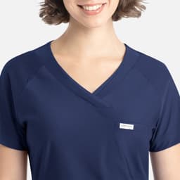 A navy blue Y-neck top featuring a pocket and a small logo on the side. The fabric appears soft and comfortable.