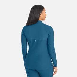 A track jacket in teal with a high collar and a logo on the back, featuring a full zip design.