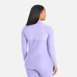 A full zip track jacket in lavender with a fitted design and a logo on the back.