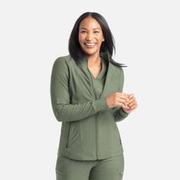 A zipped, full track jacket in olive green, featuring a collar and smooth fabric. The model is smiling and standing.