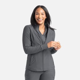 A full zip track jacket in grey, featuring a stylish collar and a fitted design, worn by a smiling woman.