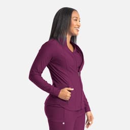 A full zip track jacket in deep plum with a fitted design and side pockets, featuring a logo on the chest.