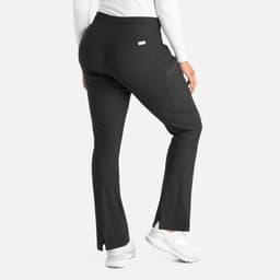 A pair of black bootcut pants with a fitted waistband and side slits at the hem, featuring a logo on the back.