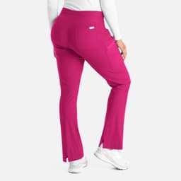 A pair of pink bootcut pants with a slight flare at the bottom and a back pocket, featuring a logo.