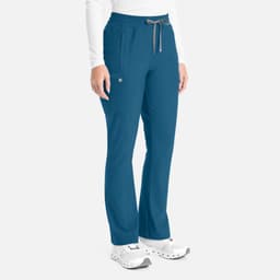 A pair of teal bootcut pants with a drawstring waist, featuring pockets and a branding logo on the side.