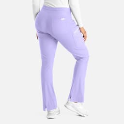 A pair of lilac bootcut pants with a pocket and side slits, viewed from the back. Features a branding logo.