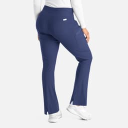 A pair of navy blue bootcut pants with side slits, featuring a waistband and a small branding logo on the back.