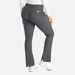 A pair of grey bootcut pants with a back pocket and subtle side slits, featuring a logo tag.