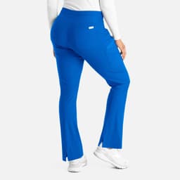 A pair of blue bootcut pants with a waistband and side slits, featuring a logo on the back pocket.