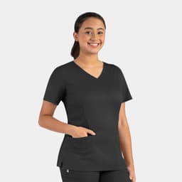 A woman wearing a black Matrix Women's Double V-Neck Top, featuring a pocket and a modern fit.