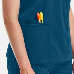 A blue women's double V-neck top with a pocket holding orange and yellow pens.